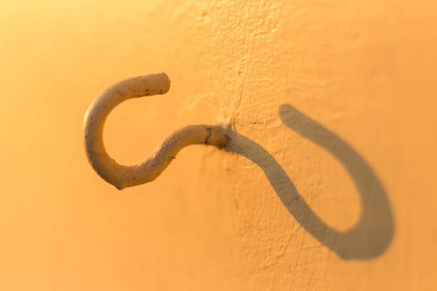 hook wall hanger isolated on orange color background with shadow,Hook for hang stick wall.
