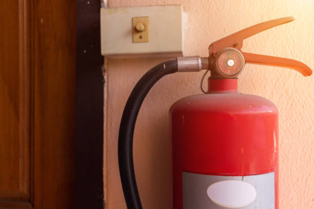 istock Red Fire extinguisher on the wall  that is installed in various building for when there is a fire. 1197232315