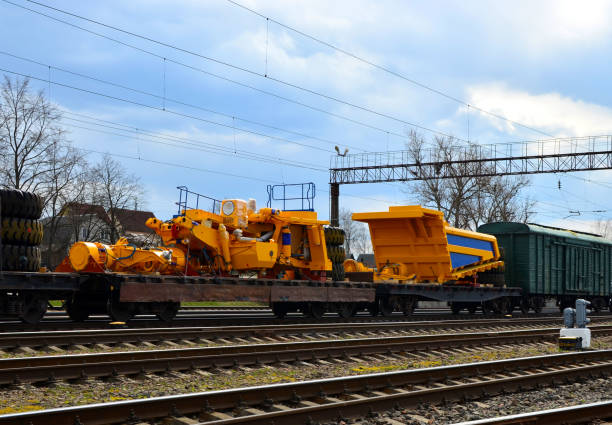 Logistics transportation heavy mining dump truck by rail. Yellow mining truck disassembled into parts, cab, body, electric motor, drive, wheels, loaded onto a cargo railway platform. - Image