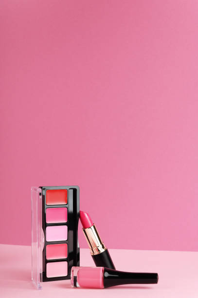 istock Lip gloss, blusher palette, lipstick on bright pink background. Decorative cosmetics products composition and place for text. Makeup items. Fashion backdrop for design with copy space. 1197233336