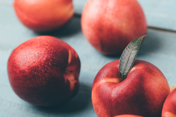 istock Sweet nectarine on wooden background 1197234969