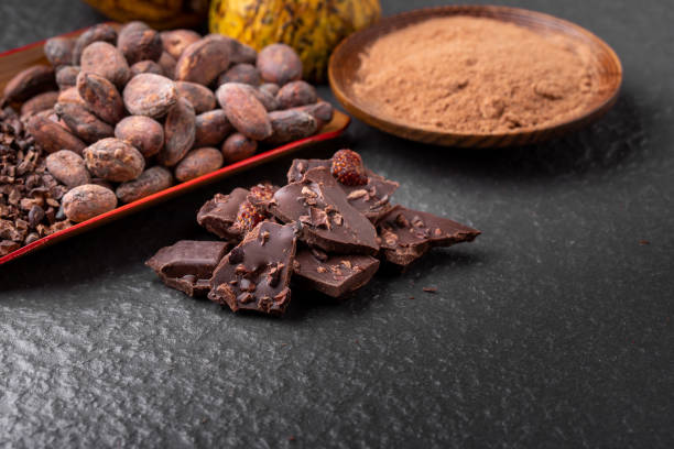 istock Cocoa beans and cocoa pod on a wooden surface. 1197234998