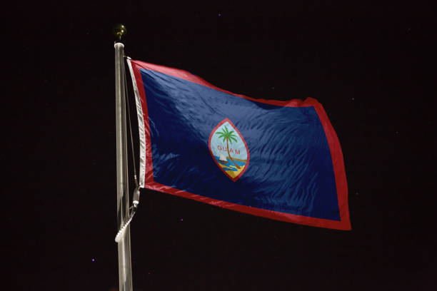 istock Guam flag blowing in the wind at night 1197235157