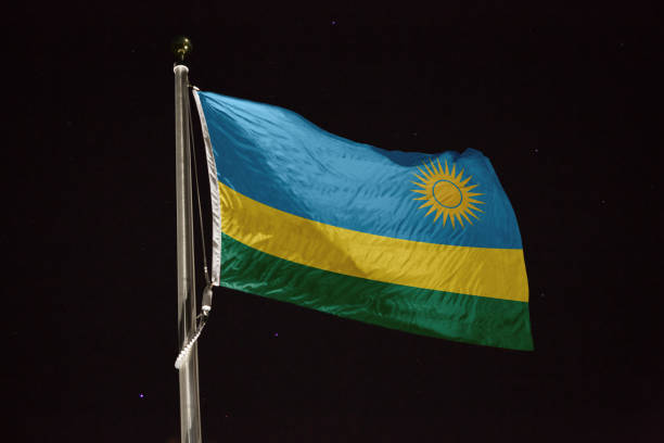 istock Rwanda flag blowing in the wind at night 1197236062