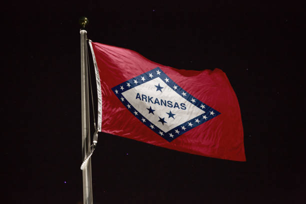 istock Arkansas flag blowing in the wind at night 1197236737