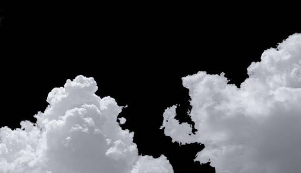 istock Pure white cumulus clouds on black background. Cloudscape background. White fluffy clouds on dark background. Soft cotton feel of white clouds texture isolated on black background with copy space 1197239453