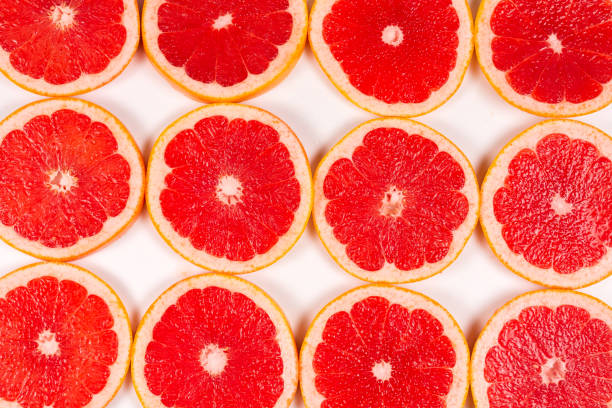 istock Grapefruit red juicy slices background. top view. 1197242016