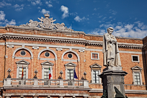 Recanati, Marche, Italy: the main square with the statue of the poet Giacomo Leopardi and the city hall in neoclassical style