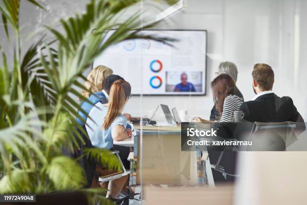 Male And Female Executive Team Video Conferencing With Ceo Stock Photo - Download Image Now