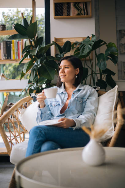 istock Beautiful woman drinking coffee at cafe 1197252877