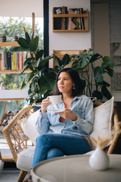 istock Beautiful woman drinking coffee at cafe 1197252901