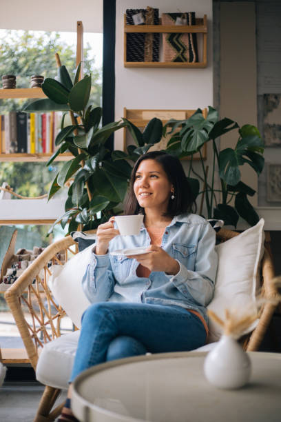 istock Beautiful woman drinking coffee at cafe 1197252910