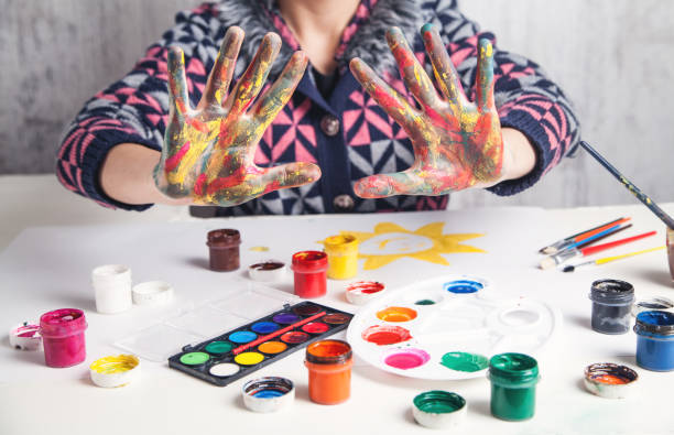 istock Girl showing hands with multicolor paint. Modern art. Hobby 1197256763