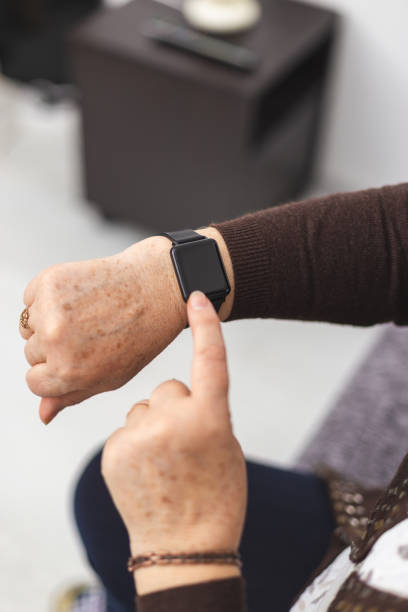 istock Old woman with a smartwatch at her wrist 1197260681