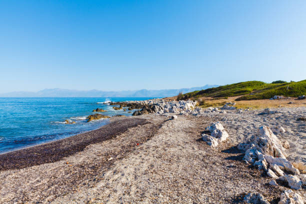 rocky beach on the island of corfu - travel destinations rocky coastline moody sky clear sky imagens e fotografias de stock