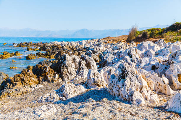 rocky beach on the island of corfu - travel destinations rocky coastline moody sky clear sky imagens e fotografias de stock