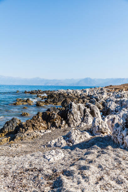 rocky beach on the island of corfu - travel destinations rocky coastline moody sky clear sky imagens e fotografias de stock