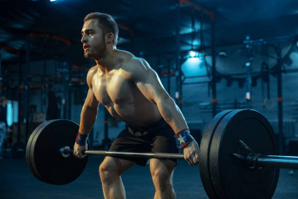 istock Caucasian man practicing in weightlifting in gym 1197262166