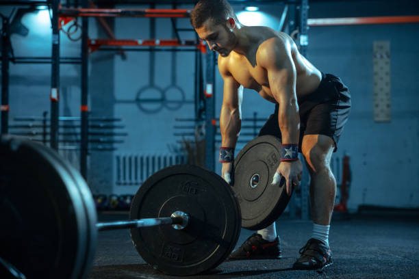 istock Caucasian man practicing in weightlifting in gym 1197262762