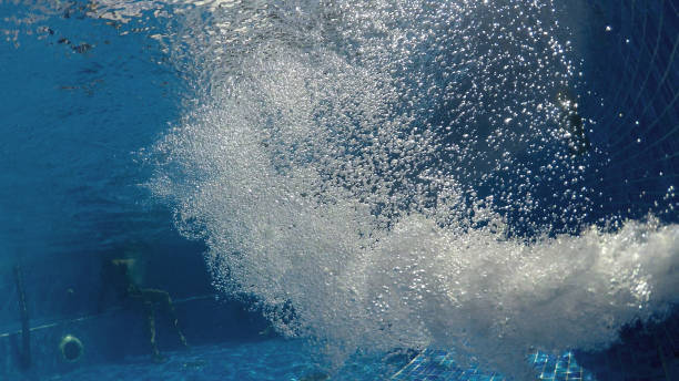 istock Air bubbles in clear blue water in pool (underwater shot), good for backgrounds 1197263421