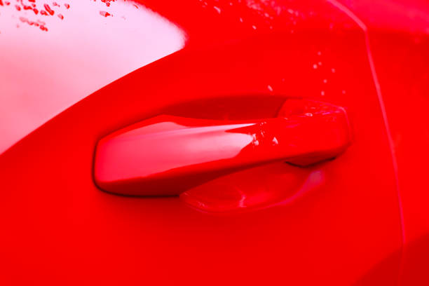 istock Door handle detail on a modern compact suv car in bright red 1197265401