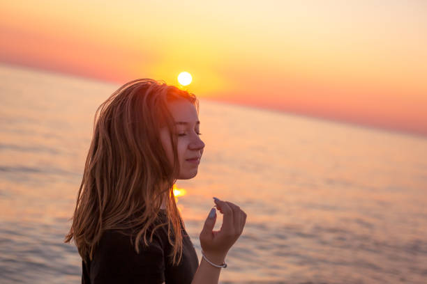 Silhouette of a girl on the beach at sunset