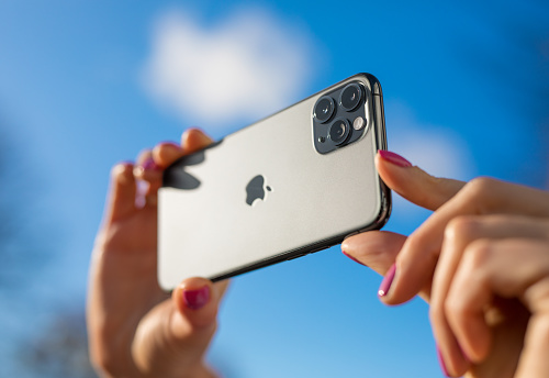 Riga, Latvia - October 28, 2019: Person taking photo with the latest Apple iPhone 11 Pro mobile phone with triple-lens camera.