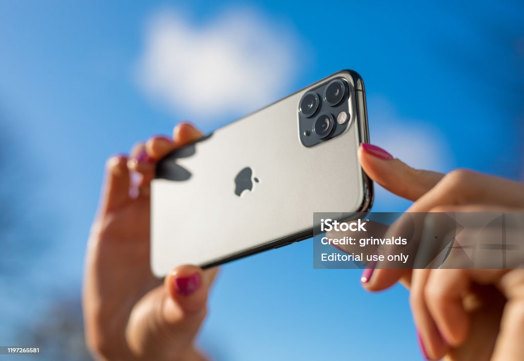 Apple iPhone 11 Pro mobile phone with triple-lens camera Riga, Latvia - October 28, 2019: Person taking photo with the latest Apple iPhone 11 Pro mobile phone with triple-lens camera. Smart Phone Stock Photo