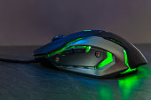 Green gaming mouse on stone texture table