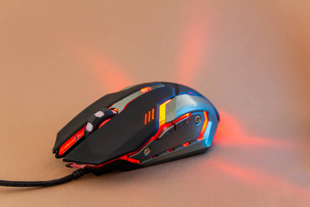 istock Red shine gaming mouse on brown background 1197265730