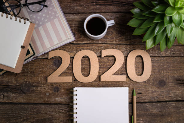 istock Office desk table with notebooks, coffee cup, american flag. New year 2020 resolutions or goals list. Goal, plan, strategy, politics, international relations, economics, american history 1197265872