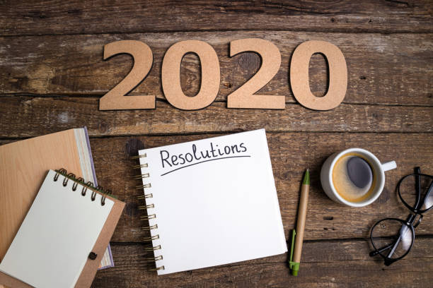istock New year resolutions 2020 on desk. 2020 goals list with notebook on office desk table. Goals, plan, strategy, change, idea, action 1197266109