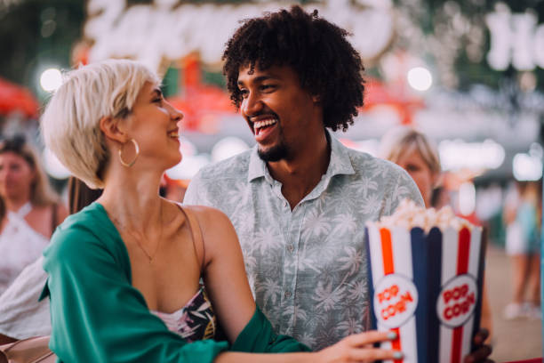 Girl and boy eating popcorns