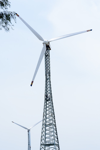 Taller hybrid tower lattice wind turbine build of rolled steel (tubular segmented) install high up 200 feet over land with 100m diameter rotor. Wind turbines widely used in renewable energy resource. In industry like roads, power collection network, substation, meteorology.