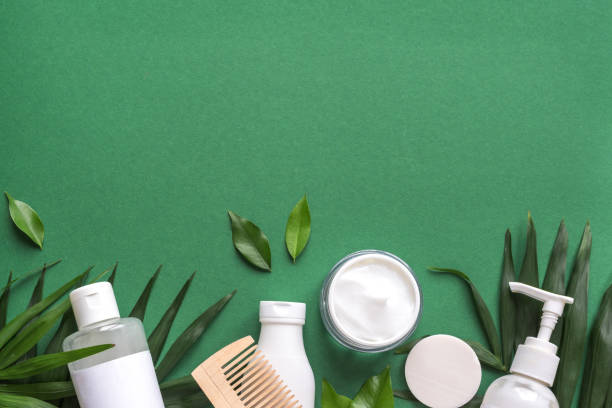 Organic Hair Care Organic Hair Care products with green leaves on green background, trendy layout, eco beauty and healthy lifestyle concept. beauty product stock pictures, royalty-free photos & images
