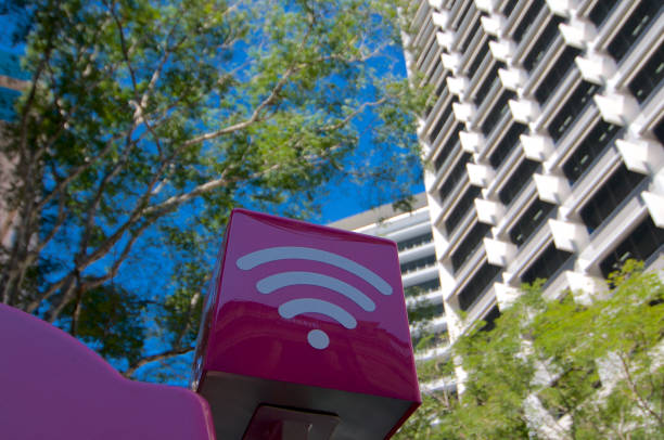 Purple colored WiFi sign Brisbane, Queensland, Australia - 7th November 2019 : Purple colored WiFi sign of the Telstra company installed on the top of a phone booth in the city of Brisbane, Australia blue pay phone stock pictures, royalty-free photos & images
