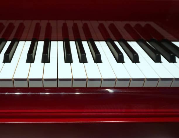 istock Piano and Piano keyboard with red,bourdeaux backgrounds. 1197269890