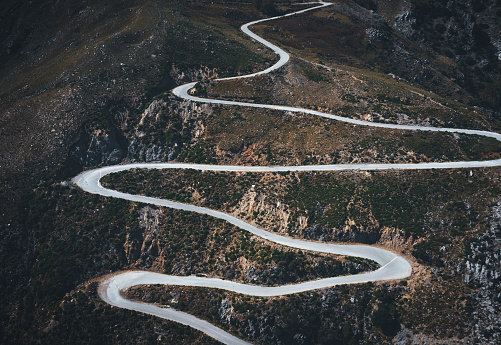 Aerial view on winding mountain road in south Chania region (Crete, Greece).
