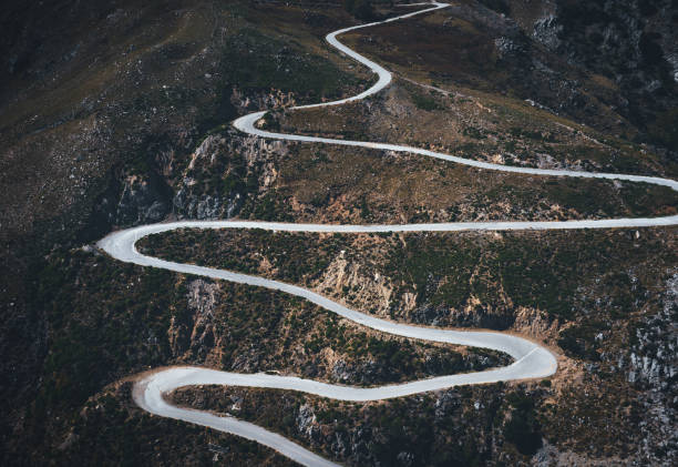 Winding Mountain Road Aerial view on winding mountain road in south Chania region (Crete, Greece). steep photos stock pictures, royalty-free photos & images