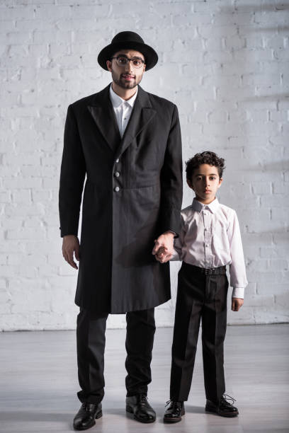 istock handsome jewish father and cute son holding hands 1197273492