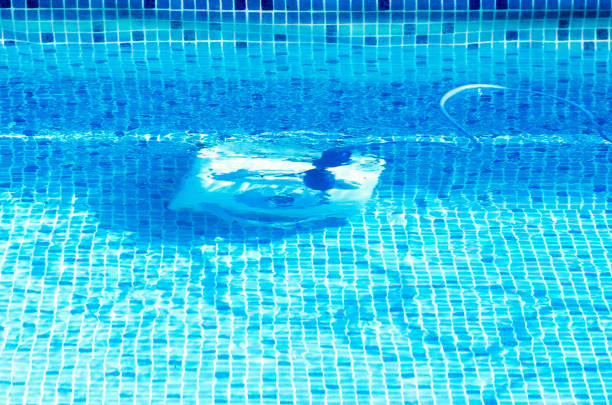 istock Cleaning the pool bottom with an underwater vacuum cleaner 1197276812