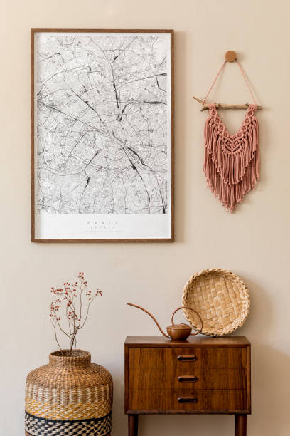 istock Modern scandinavian living room interior with mock up poster frame, design retro commode, macrame, rattan decoration and elegant personal accessories. Japandi. Template. Stylish home decor. Beige wall 1197278390