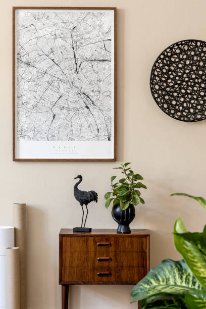 istock Modern scandinavian living room interior with brown mock up poster frame, design retro commode, rattan decor, plant, maps and elegant accessories. Template. Stylish home staging. Japandi. 1197279213
