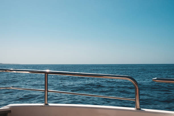 istock ocean and blue sky / sea view horizon behind boat railing 1197279405