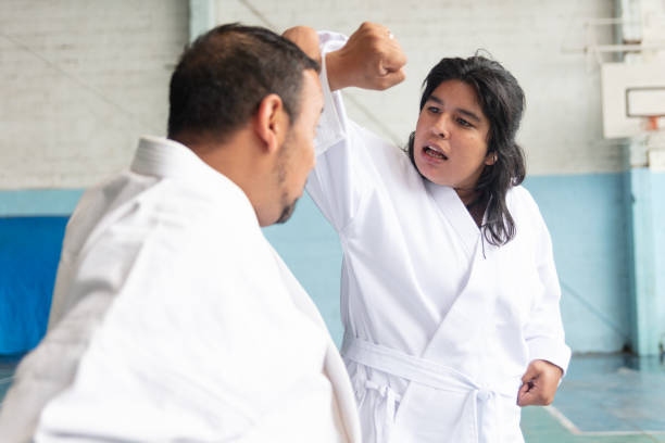 istock Latin young woman with disability practicing parakarate with a teacher 1197281241