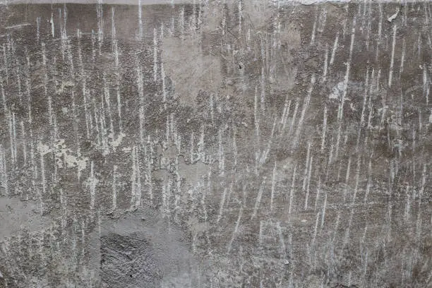 Photo of concrete wall with removed old paint and lime mechanically close up