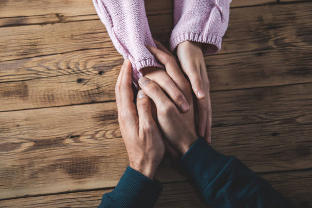 istock woman and man hands on desk 1197283010