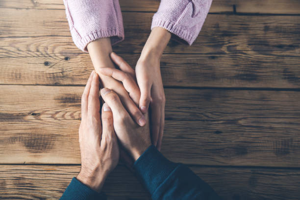 istock woman and man hands on desk 1197283014