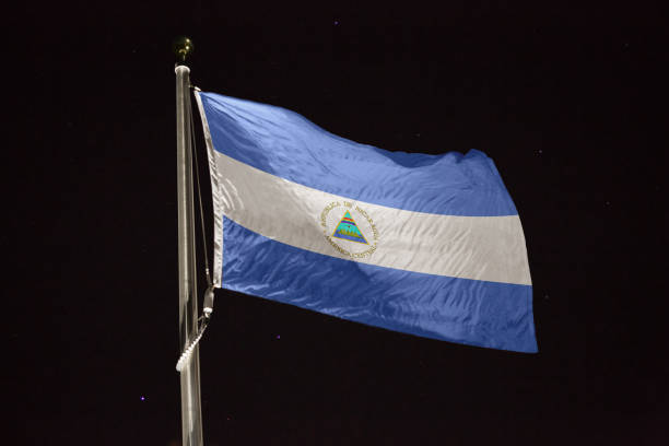 istock Nicaragua flag blowing in the wind at night 1197283156