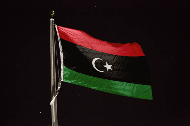 istock Libya flag blowing in the wind at night 1197283314